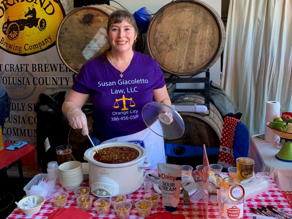 Attorney Susan Giacoletto serving chili at a fundraising cook-off